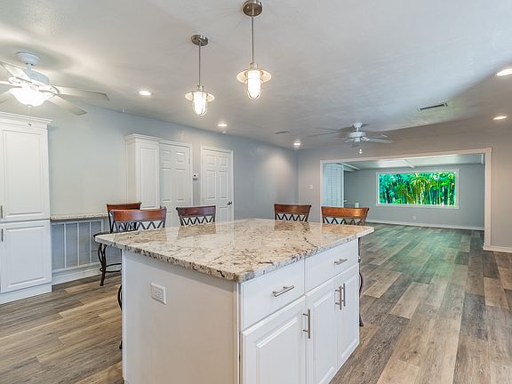Remodeled Kitchen with pantry, stainless steel appliances, stunning granite with granite backsplash, white cabinets, natural day light and open floor plan.