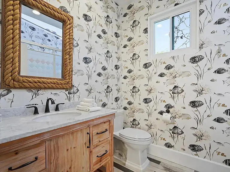 Full guest bathroom with charming decor.