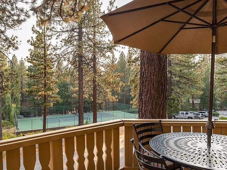 Outdoor patio set with view of community tennis and pickle ball courts.