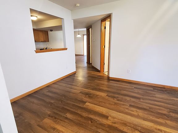 Living area with view of pass thru area to kitchen. LVT planking for flooring