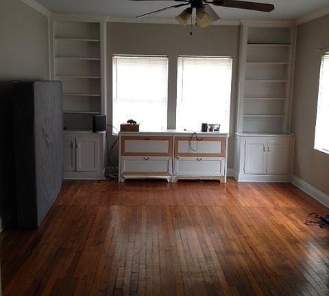 12.5' x 20' Living room. Built-ins in corners. Center cabinet between built-ins does not stay.