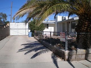 Driveway parking with gate to back Carports