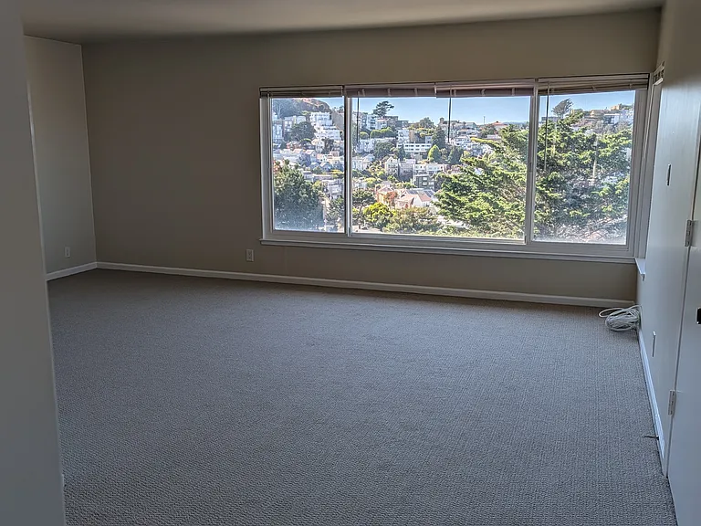 Living area with light over eating nook taken from kitchen