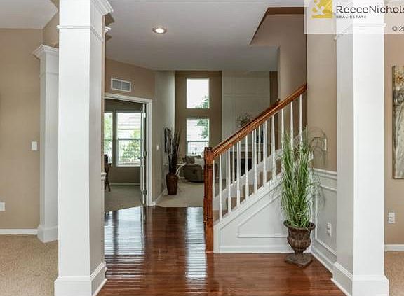 Soaring two story entry with hardwood floors welcome you and you