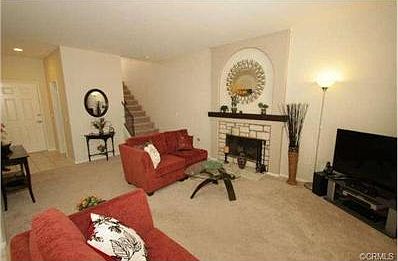 The welcoming Entry-level living room has a gorgeous stone firep