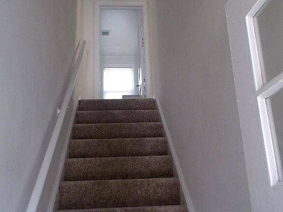 Private locked entrance with stairs leading to upper level apartment