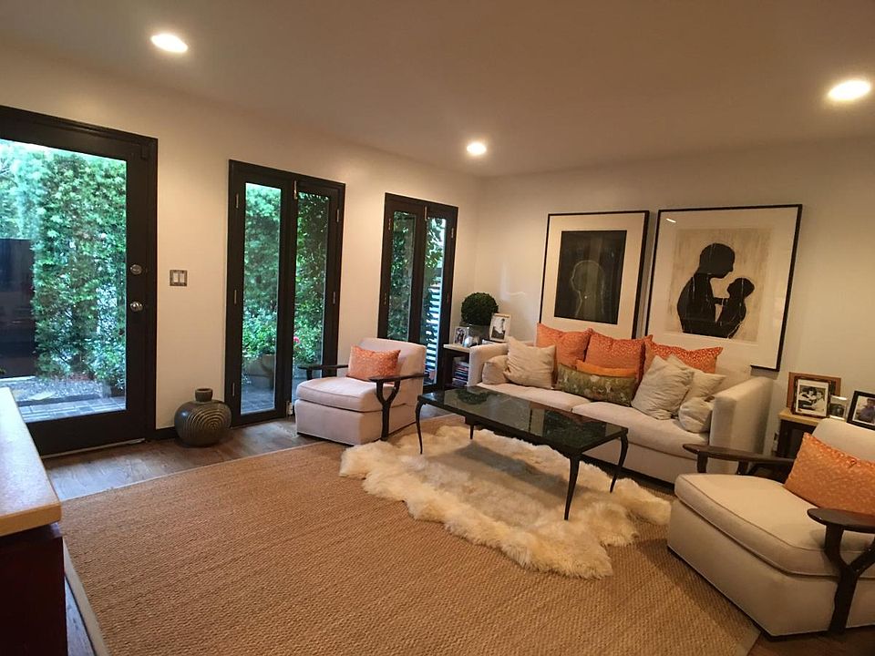 Living room with natural lighting from floor to ceiling windows