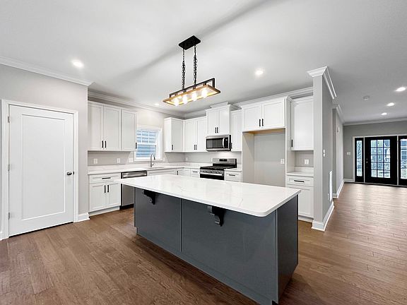 Kitchen - grey island cabinetry, white kitchen cabinetry, quartz countertops, stainless appliances,