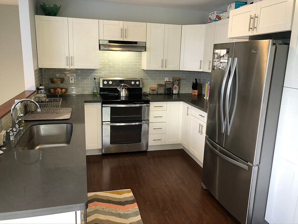 Open concept kitchen with New fridge/ freezer, oven and sink. Lots of storage!
