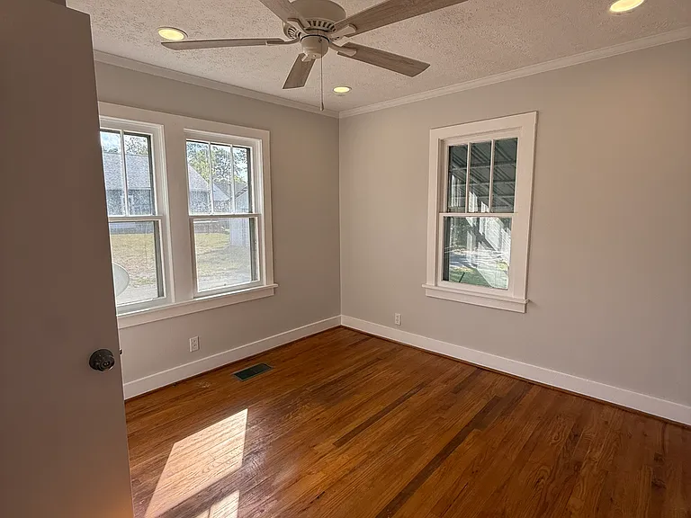 Bedroom 1 or 2 with closet and plenty of natural lighting.