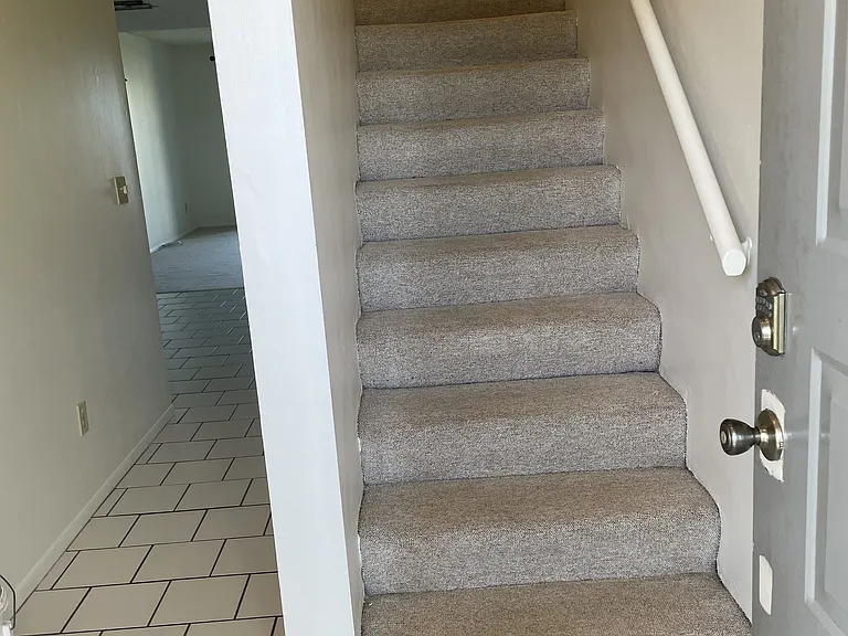 FOYER, STAIR & CORRIDOR TO DINING, HALF BATH, LIVING & BALCONY