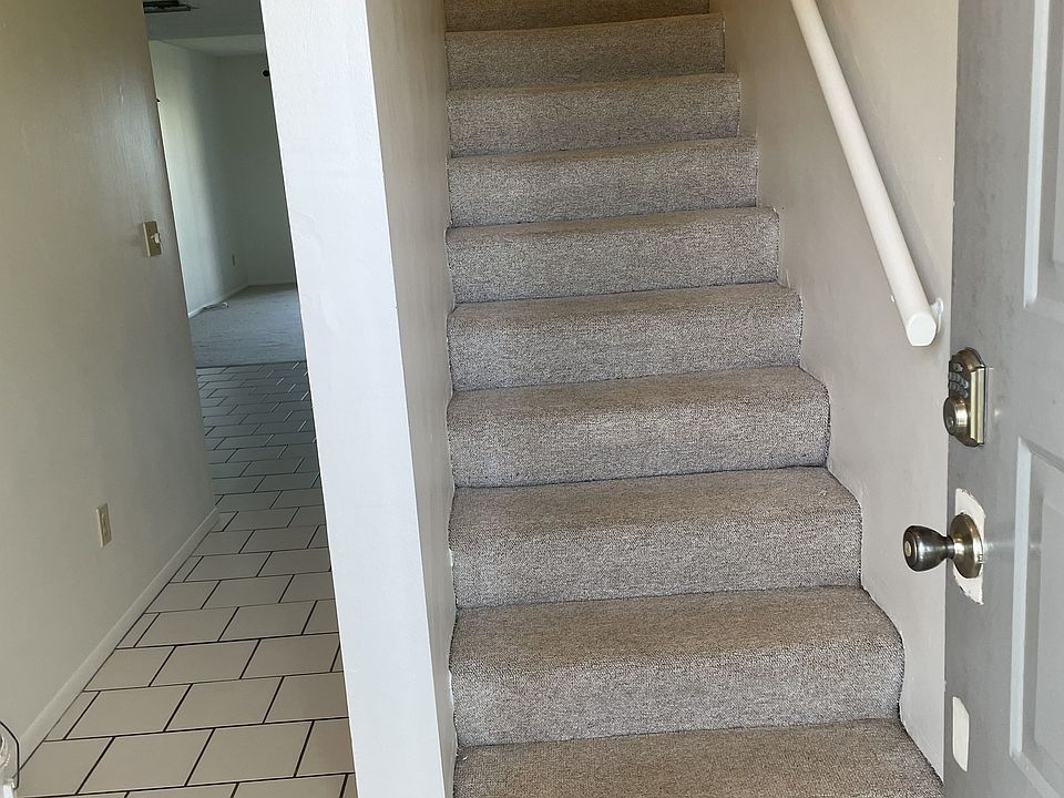 FOYER, STAIR & CORRIDOR TO DINING, HALF BATH, LIVING & BALCONY