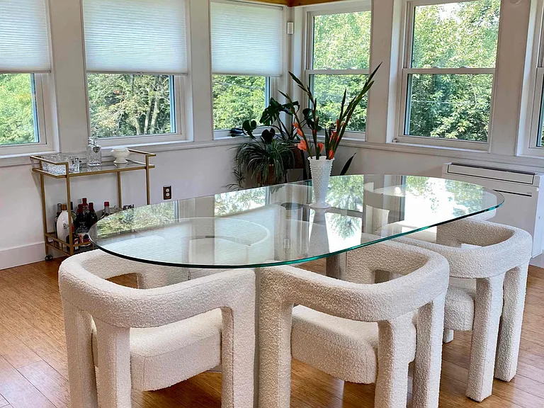 4 seasons room with seating for 6 and views of the backyard
