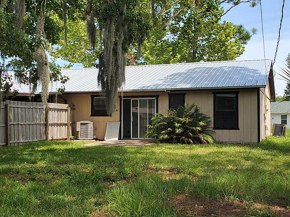 Huge private backyard accessed via sliding door in kitchen