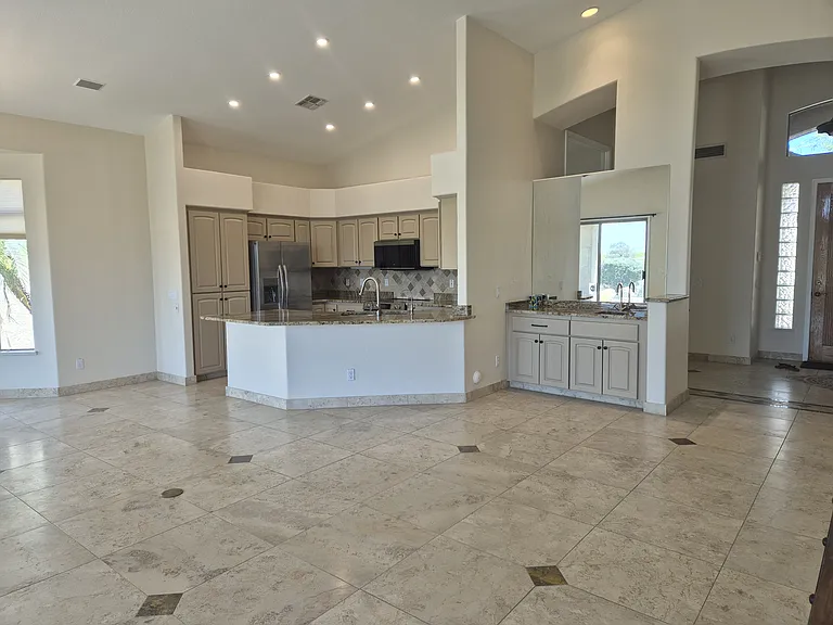 Open concept kitchen and great room with travertine flooring