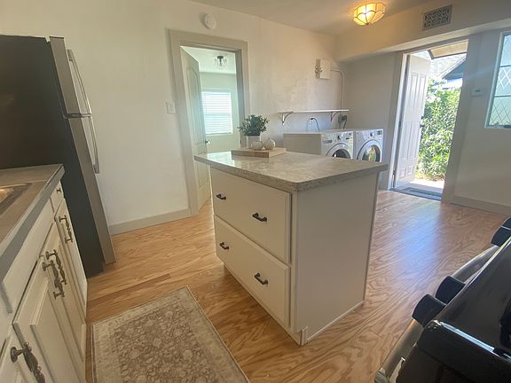 Kitchen features a quartz-top kitchen island with two spacious storage drawers