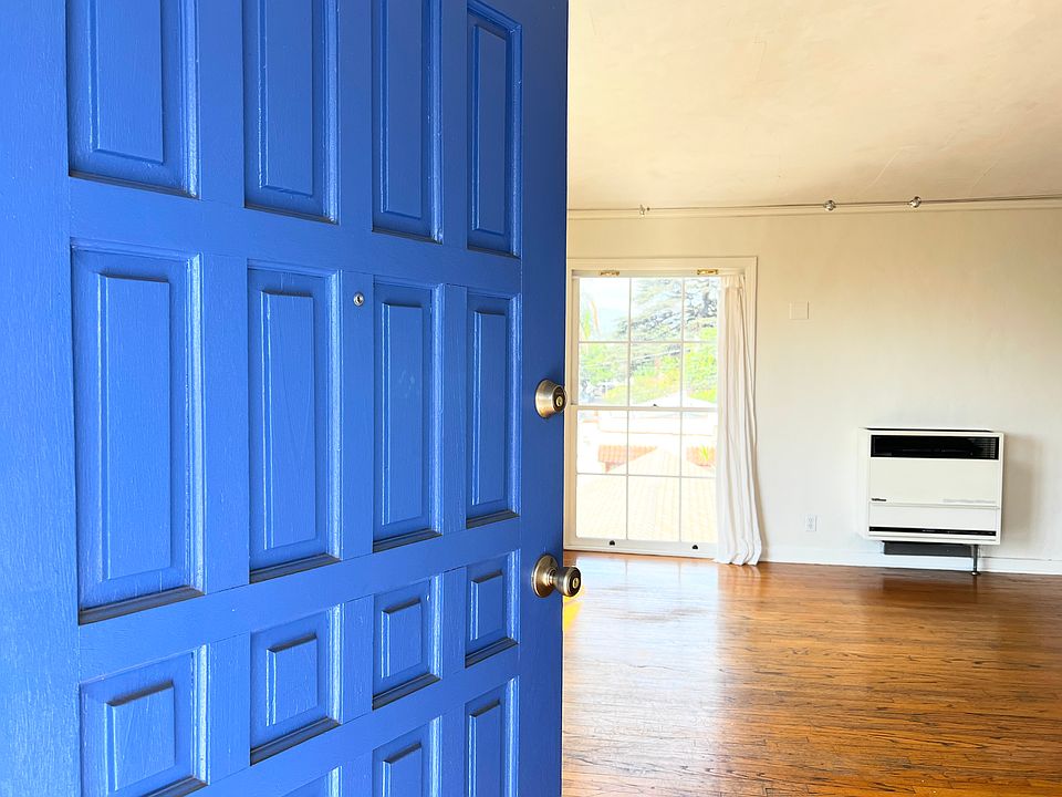 Front door opening in 1930's hardwood floor living room