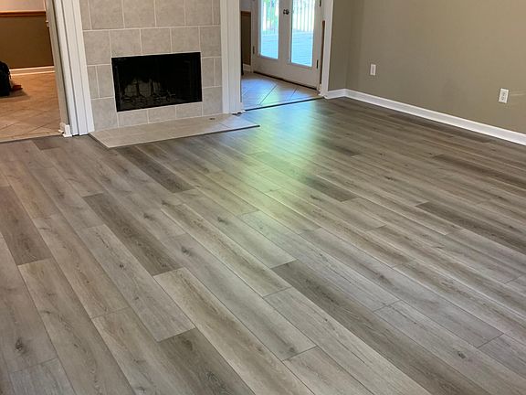 Living room with new LVT floor and tiled fireplace