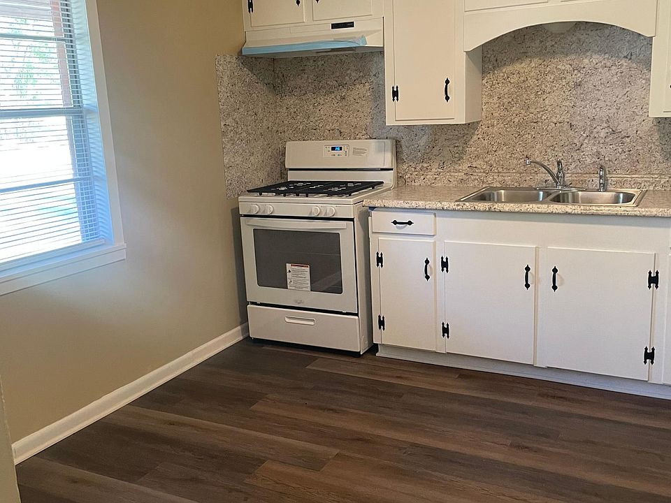 Brand new gas range and vent hood.