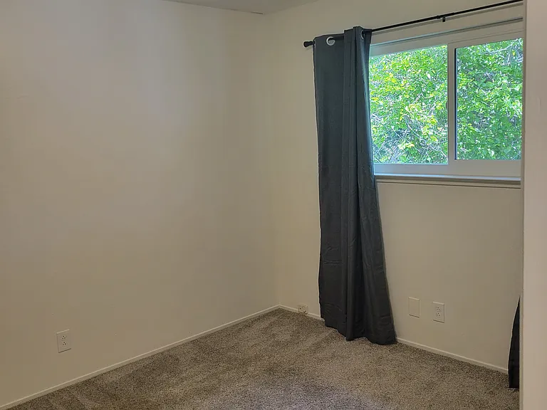 Spacious bedroom with large windows and black out curtains