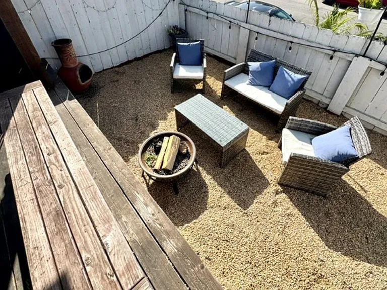 Wooden deck seating 8 with gas grill and comfy seating for 4 by the fire