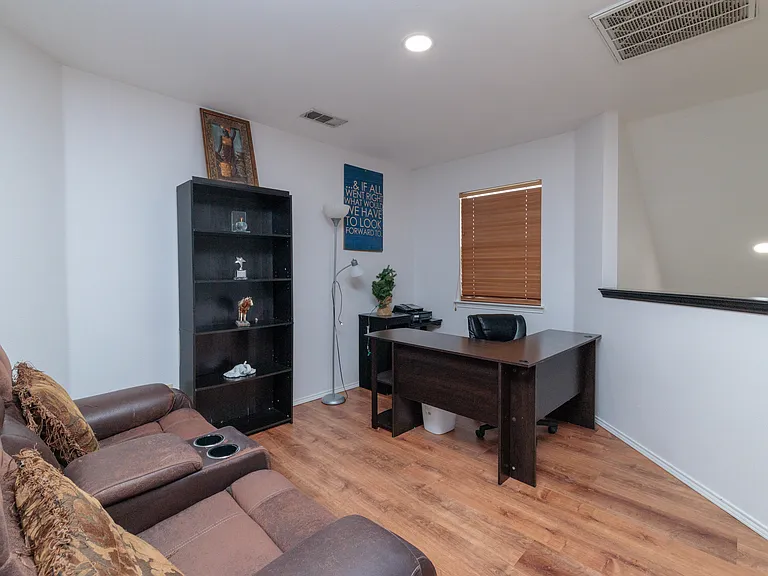 Loft office with desk, chair and double recliner.