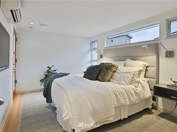 The Primary Suite features hardwood floors, its own heating and cooling system, and built-in, floating side tables.   Notice the solid wood, fir door package that you will find throughout the home.