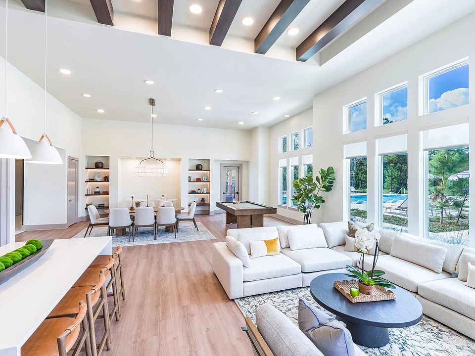 Expansive clubroom with gathering space, lounge seating, and billiards.