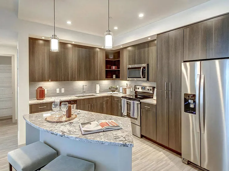 Kitchen View Includes Bar Counter, Pendant Lighting, and a Walk-In Pantry Entrance