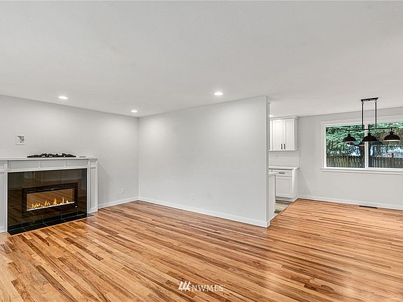 Comfortable Living room with newly finished REAL hardwood floors and new electric fireplace that heats the entire area