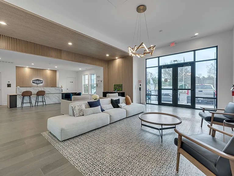 Elevate your lifestyle at Crossings @ 501 Apartments. This stunning lounge area combines modern design with comfort, perfect for relaxation or socializing. Don't miss out on this inviting communityschedule your tour today!