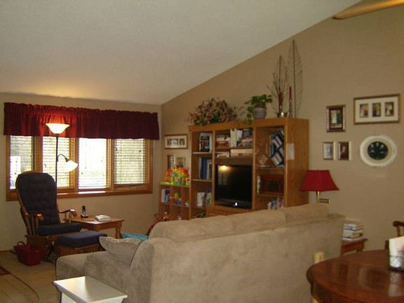 The living room has neutral colors, a vaulted ceiling, and lots of natural light through the large front bay window.br /The room is currently carpeted, but there is hardwood floors underneath!