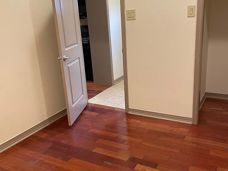 Bedroom facing foyer and entrance to the kitchen