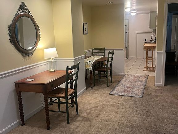 Part of living room. Entryway closet on left