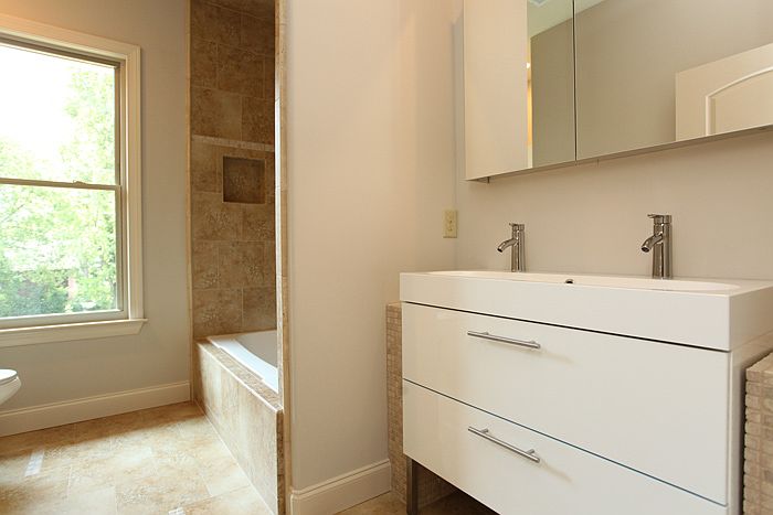 Gracious hall bath with plenty of natural light