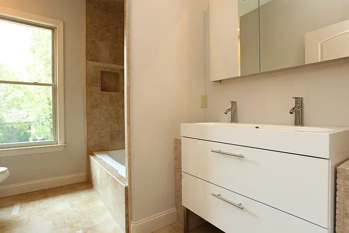 Gracious hall bath with plenty of natural light