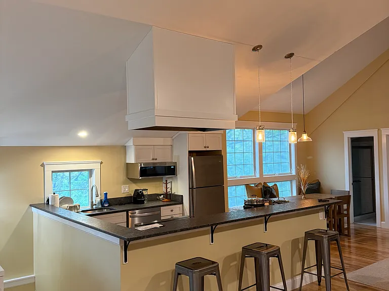 Open full kitchen with large bartop