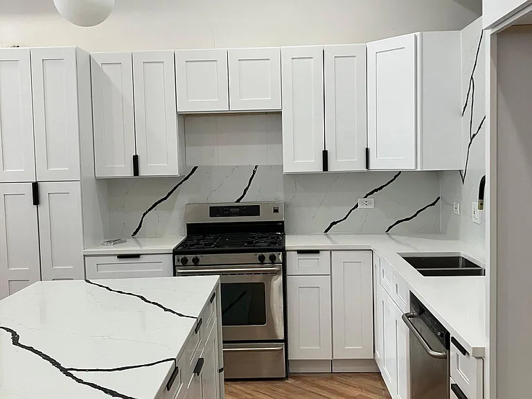 new kitchen cabinets w/quartz founder and backsplash