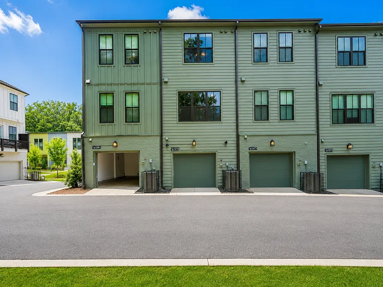 Back of property with view of garage