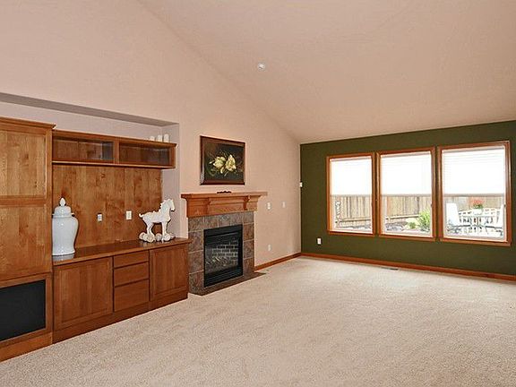 Great room with gas fireplace, soaring cathedral ceilings and built-in entertainment center