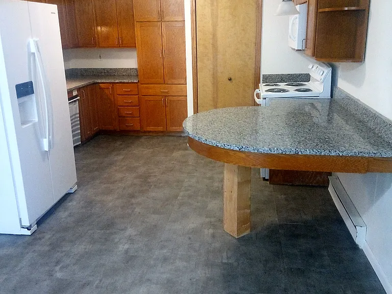 View of the kitchen and utility closet from living room.