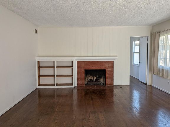 Living room with fireplace and built-in shelves.