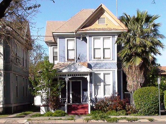 Classic, Vintage and Victorian!  Add some cosmetic repairs and personal touches to restore this charming duplex to its original pride.  Driveway to the left goes to the back for parking and garage.