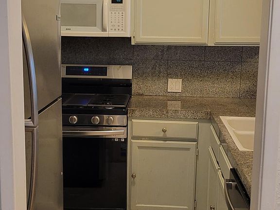 Kitchen with brand new stove, refrigerator, and dish washer