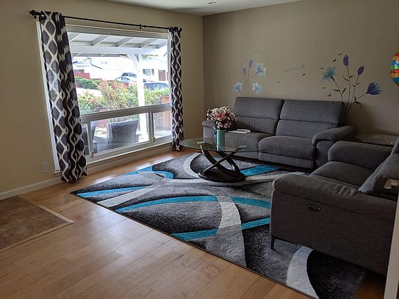 The living room now has newly refinished floorings. The entire house has this color flooring now.