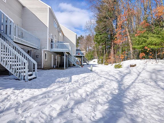 Back of townhouse showing deck with stairs down to open comm