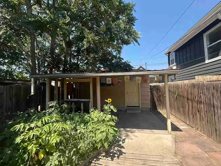 Detached oversize garage, sunflower bed needs maintenance by tenants or landlord