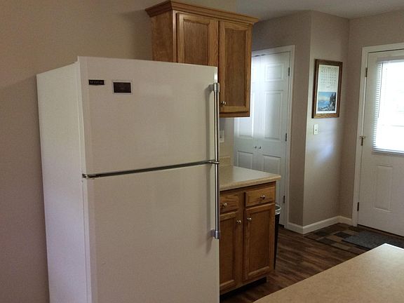 Kitchen area with refrigerator