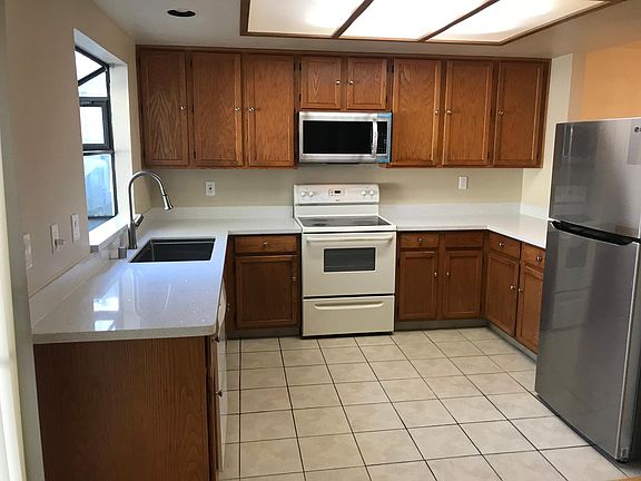 Kitchen - New counter-top, sink, faucet, refrigerator, and microwave