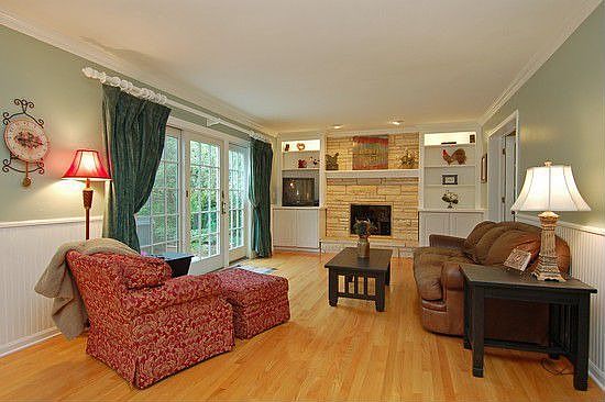 FAMILY ROOM/LIMESTONE FIREPLACE~CUSTOM CABINETS/HARDWOOD